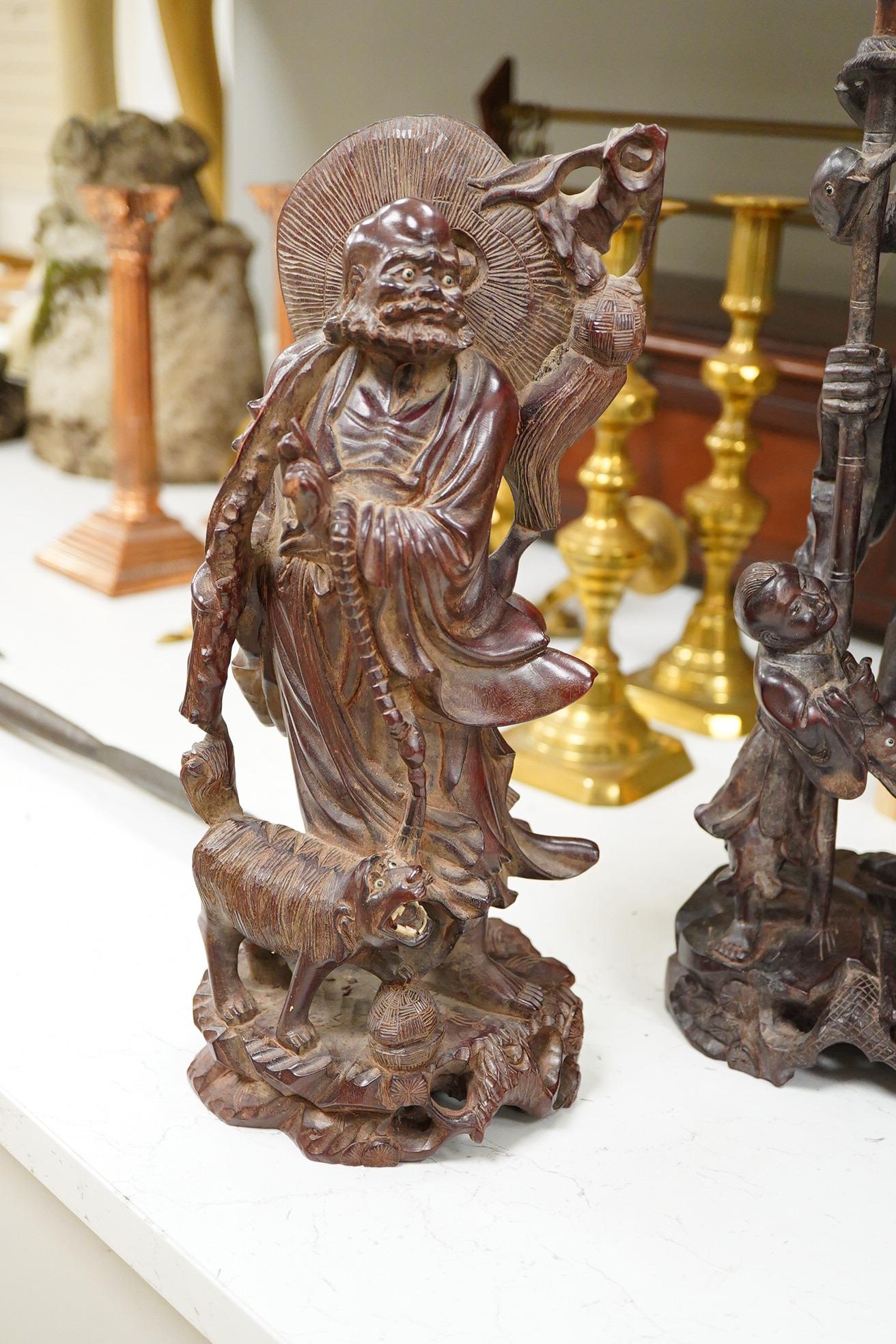 Three Chinese carved wood figures; Shou Lao, a fisherman and a Luohan, tallest 39cm